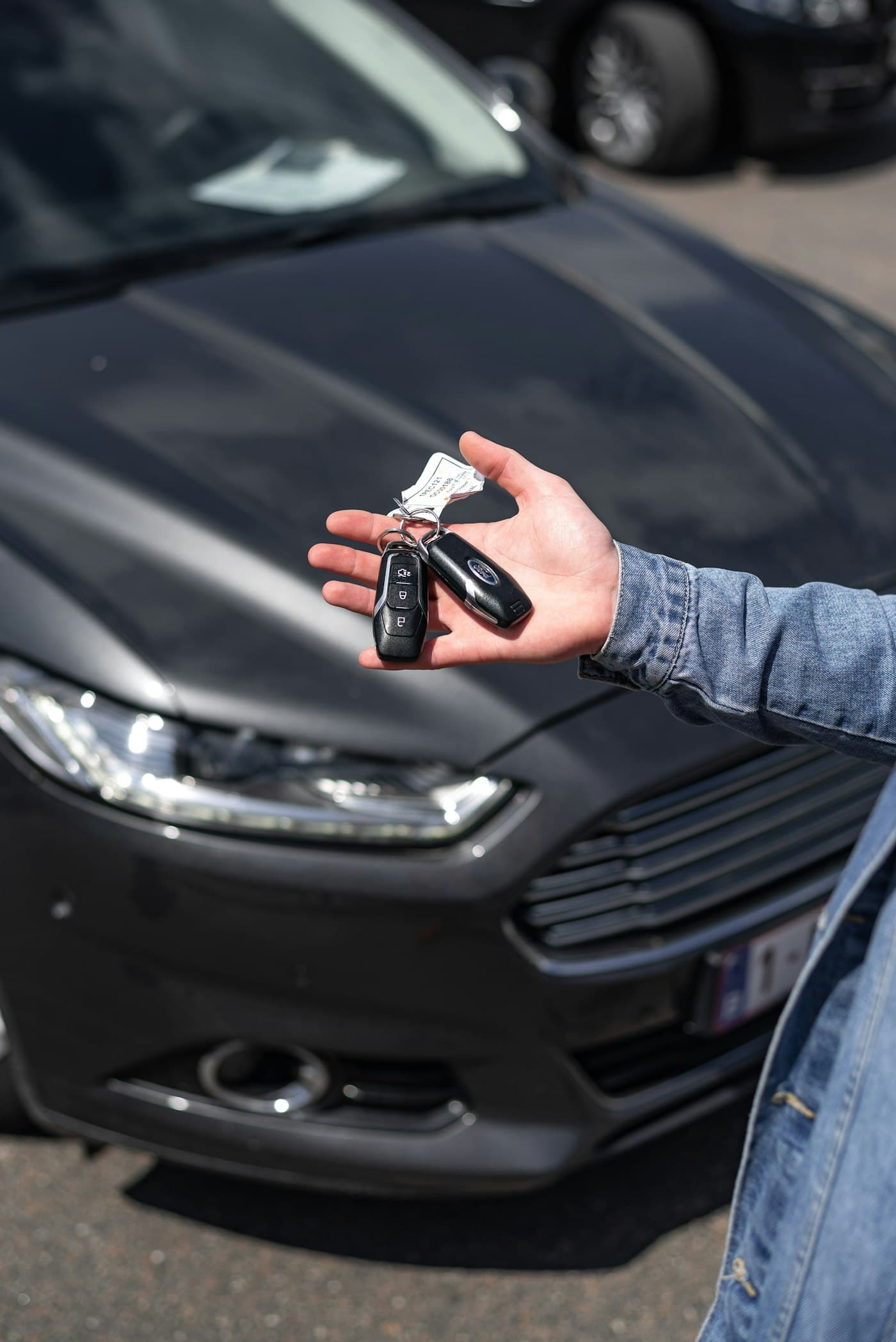 Keys handed over in front of the car