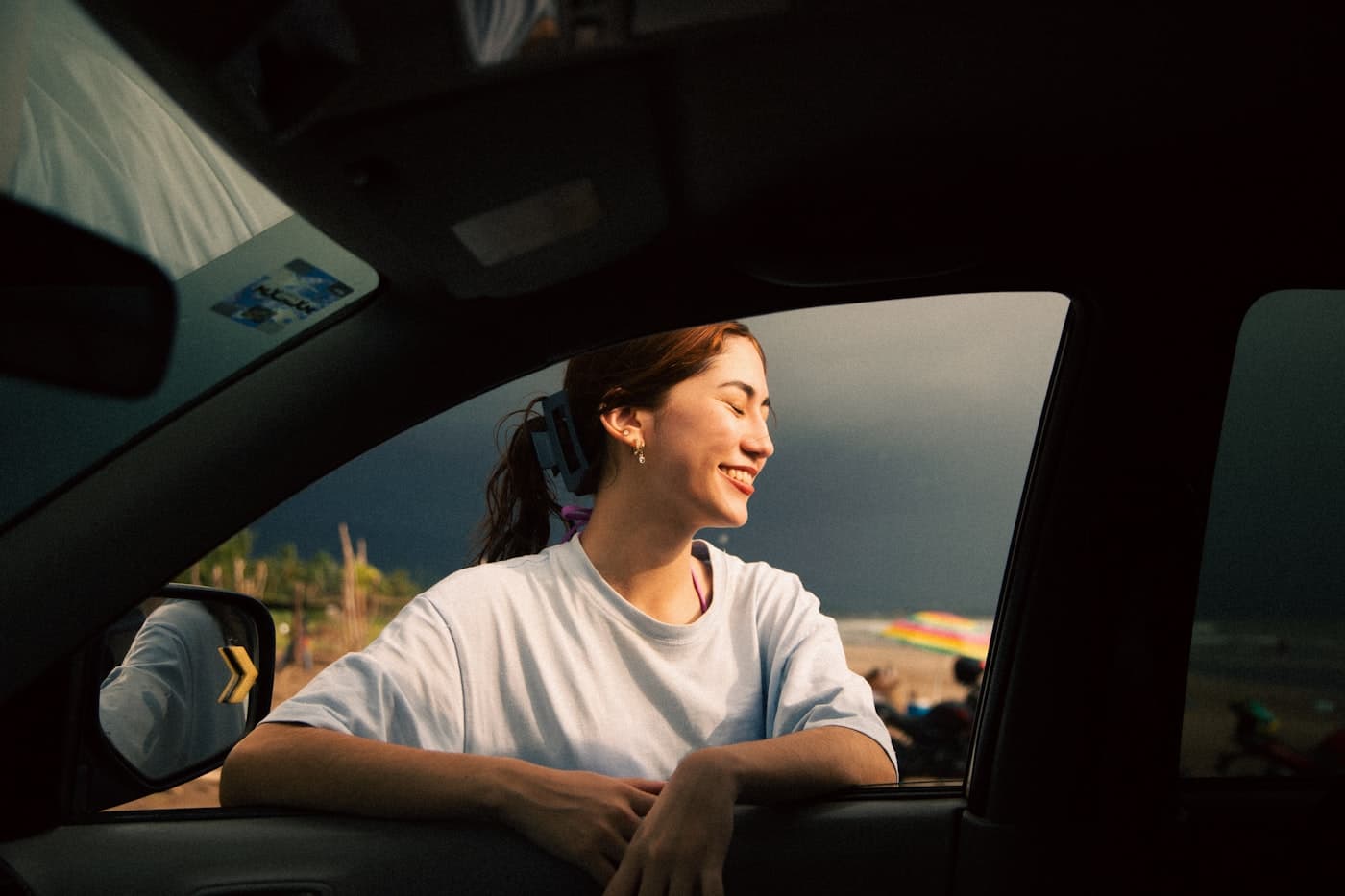 Driver smiling out the window at sunset